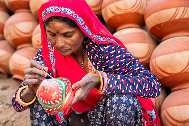 istock Potter painting a decorative clay pot, Jaipur, India 2247254468