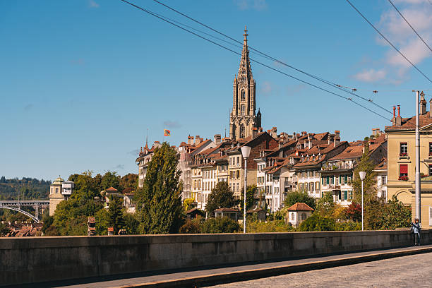 Bern cityscape featuring the minster cathedral spire rising above traditional buildings and rooftops