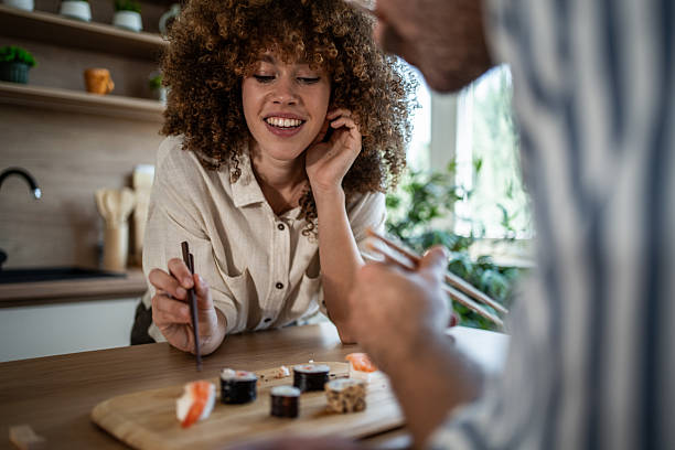 istock Couple enjoying sushi dinner in home kitchen 2247255006