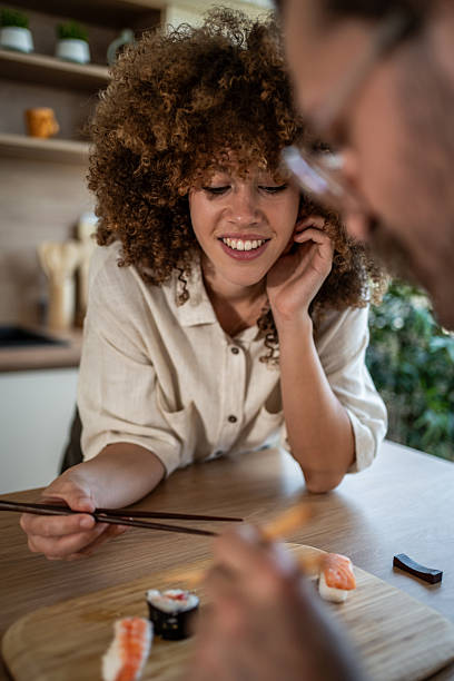 istock Couple enjoying sushi lunch together at home kitchen 2247255012