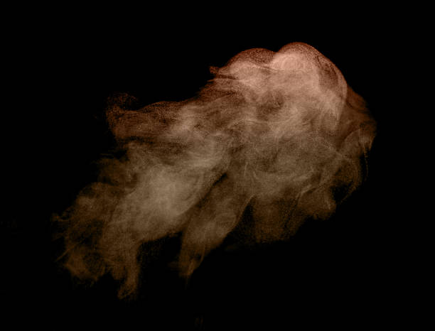 istock Dynamic cloud of brown dust particles floating and dispersing on a black background, creating a dramatic abstract texture ideal for design overlays, motion effects, artistic compositions, and visual. 2247257646