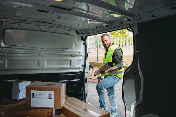 istock Man delivering packages from back of delivery van 2247258897