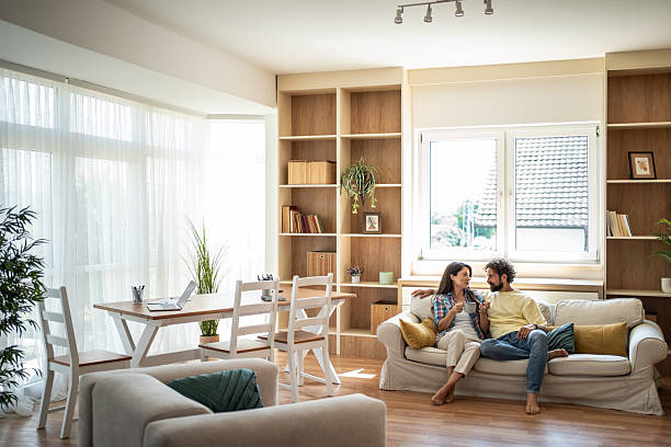 istock Young couple relaxing on sofa enjoying morning coffee at home 2247259283