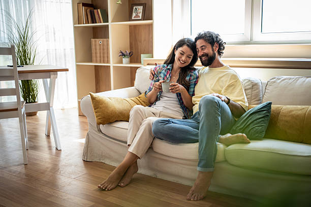 istock Happy couple relaxing on sofa feeling cozy at home 2247259307
