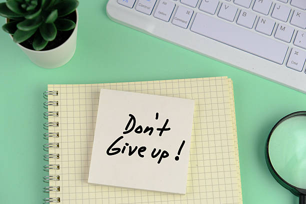 istock Dont give up written on notepad on clean desk 2247259804