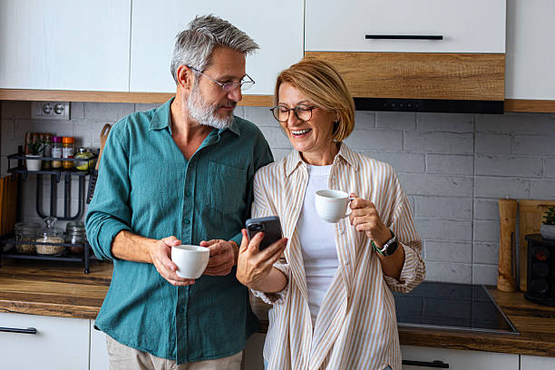 istock Retired Couple Browsing on Phone Over Morning Coffee 2247260539