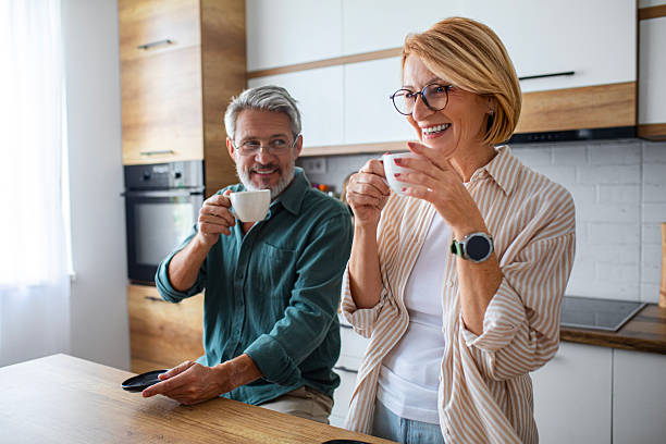 istock Senior Couple Enjoying Morning Coffee in the Kitchen 2247260619