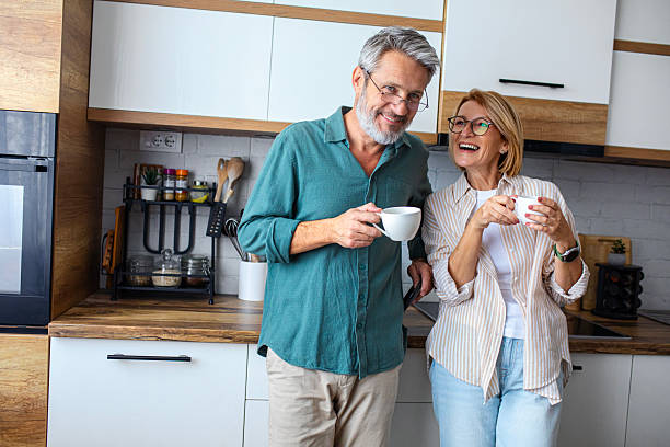 istock Senior Couple Enjoying Morning Coffee in the Kitchen 2247260855