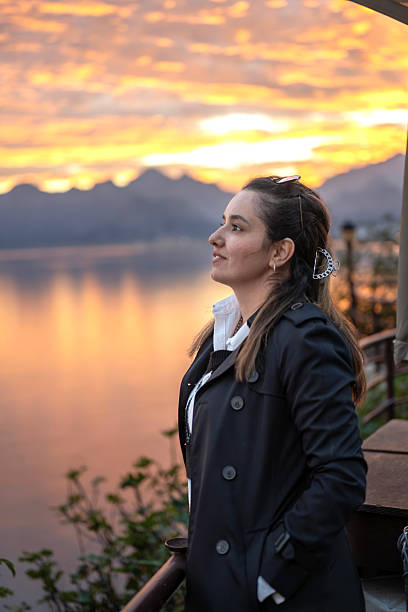 istock Young woman relaxing on balcony at sunset 2247262702