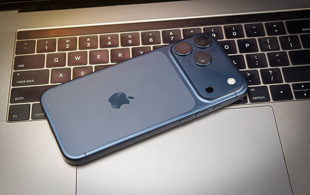 Iphone 17 Pro Max on top of laptop keyobard, latest mobile launch banner.