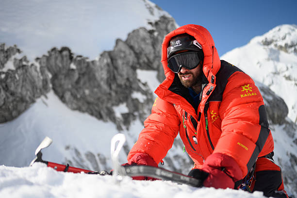 istock Mountaineer in Red Jacket Navigating Snowy High Mountain Terrain with Determined Focus 2247264156