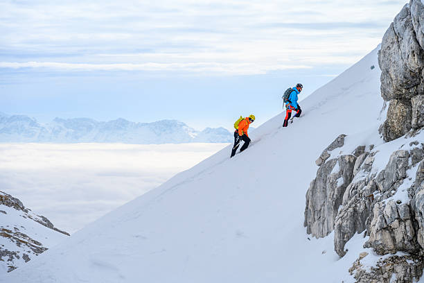 istock Determined Mountaineers Climbing Steep Snowy Slope During Alpine Winter Expedition 2247264178