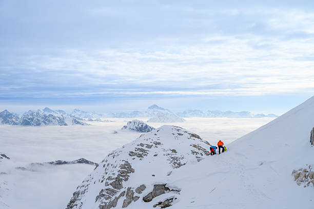 istock Winter Mountaineers Enjoying Rest on Snowy Slope with Misty Mountain Backdrop 2247264189
