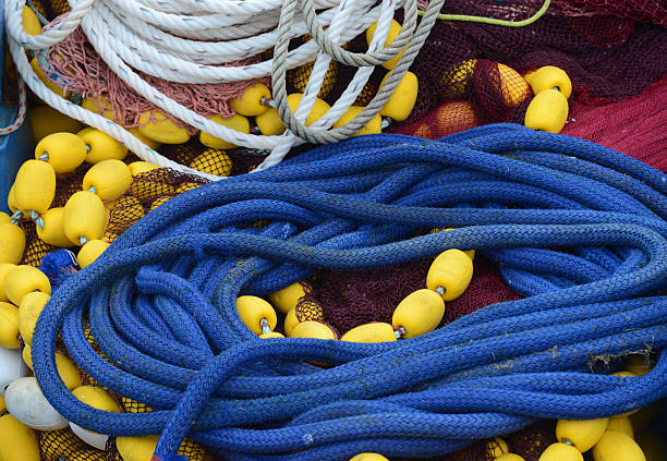 mixed and colorful nets, ropes and boat floats on a harbor in Britanny
