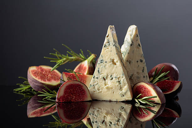 istock Blue cheese with fresh figs and rosemary on a black background. 2247265444