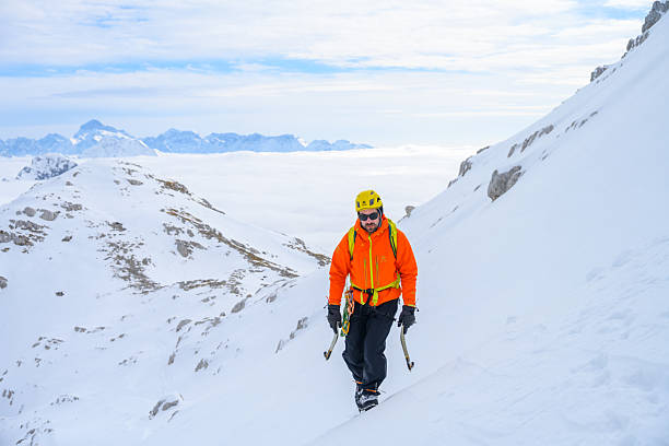 istock Confident Mature Caucasian Man Climbing Snowy Peaks with Determination 2247267380