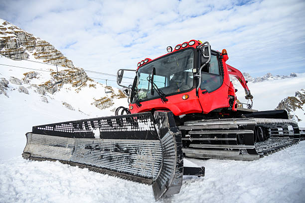 The red snow groomer prepares the ski slope on the Hintertux Glacier in the Zillertal - Austria