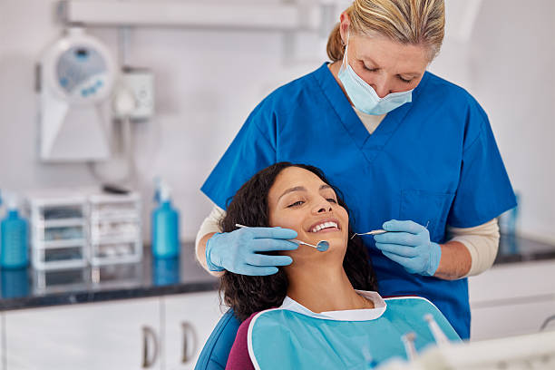 istock Mature dentist making treatment in modern clinic 2247268191