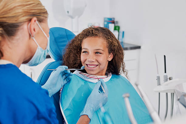 istock Cute little girl smiling during dental visit 2247268250