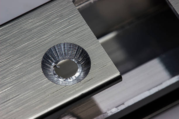 a countersunk milled hole in an aluminum facade profile in close-up. a macro photo of the production process. an illustration. a space for text