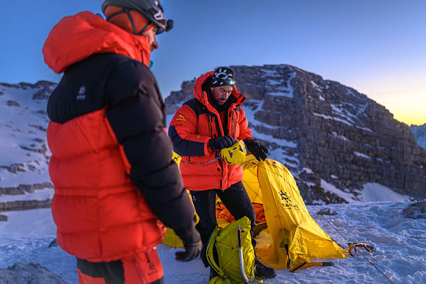 istock Mountaineers Preparing Equipment with Determined Focus at High Mountain Base Camp 2247270427