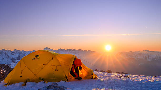 istock Caucasian Mountaineer Emerging From Tent at High Mountain Base Camp During Sunrise 2247270452