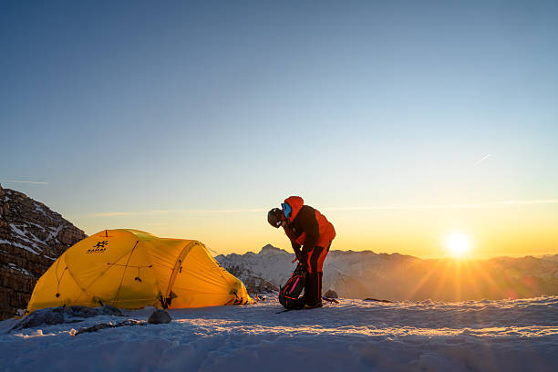 istock Experienced Mountaineer Organizing Gear at Sunrise in High Mountain Base Camp 2247270466