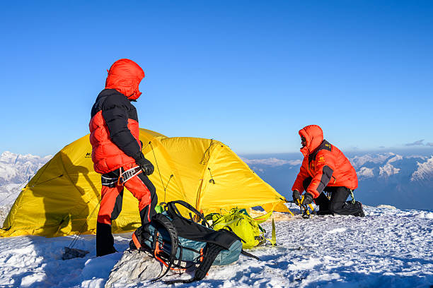 istock Mountaineer Carefully Setting up Tent in High Mountain Base Camp with Determined Focus 2247270535