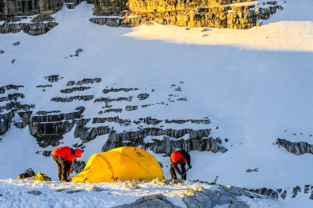 Tent near mountain lake at camping in twilight