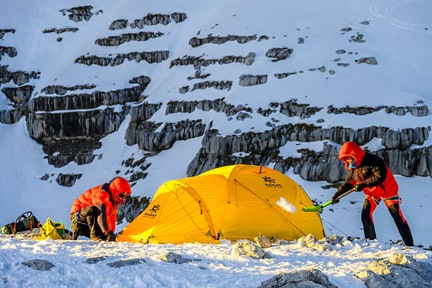 istock Mountaineer Preparing Tent in Snowy High Mountain Base Camp During Daytime 2247270558