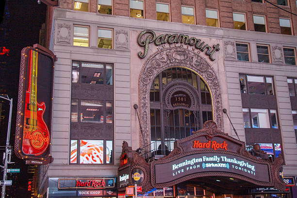 The Historic Paramount building hosting Hard Rock Cafe restaurant at Times Square with its billboards at night in Midtown Manhattan,  New York City, USA