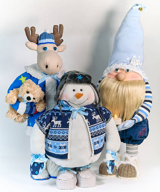 istock Three Christmas interior figurines (snowman, elk, gnome) in a blue outfits on a white background 2247271672