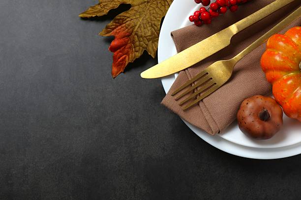 istock Close-up of table setting with pumpkins, dinnerware, rustic napkin on a plates. Thanksgiving day 2247271695