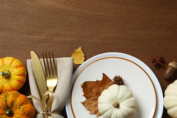 istock Rustic holiday table setup. Top view with plates, cutlery and autumn decorations. Empty space for your text 2247273305