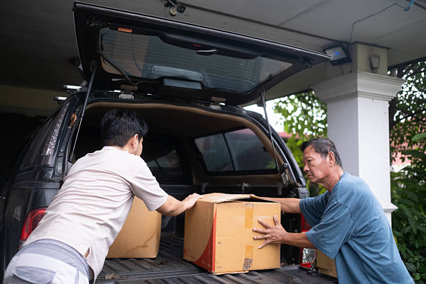 istock Two men are lifting a box into a truck 2247273972