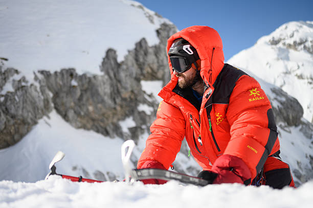 istock Professional Mountaineer in Bright Gear Navigating Snowy High Mountain Terrain with Determination 2247274016