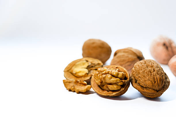 istock Whole and shelled walnuts on the white background 2247274187