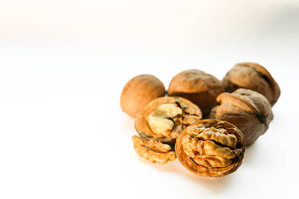 istock Whole and shelled walnuts on the white background 2247274226