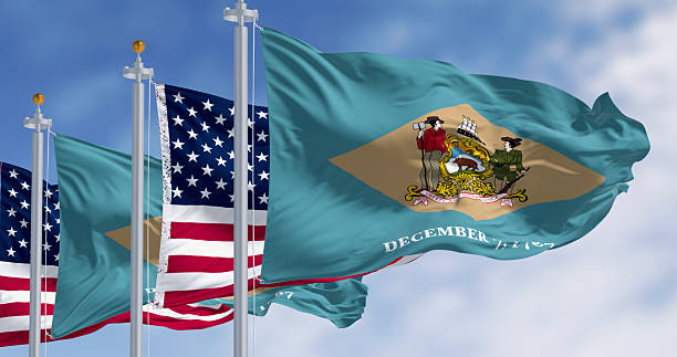 istock Delaware state flag waving with the national american fla 2247274232