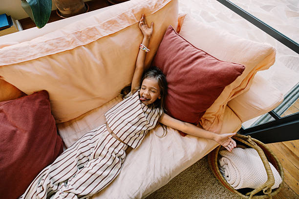 istock Relaxing at home with girl on couch 2247274584