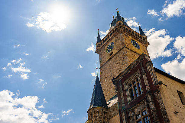 Sun shining over Prague's Old Town Hall.