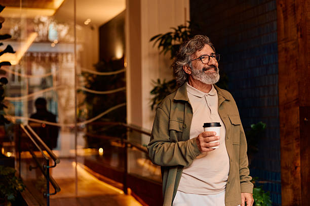 istock Mature adult man smiling holding coffee cup 2247277019