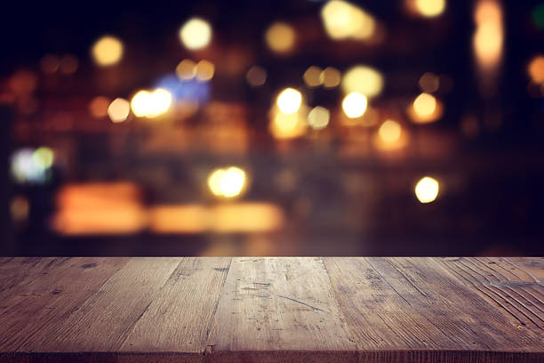 istock background Image of wooden table in front of abstract blurred restaurant lights 2247277322