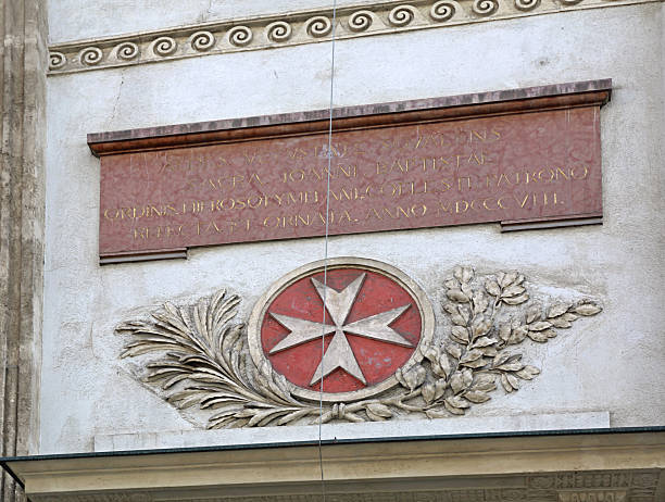 Vienna, Austria - July 12, 2015: Maltese Cross Sign and Plaque at Saint John the Baptist Church Building in Capital City.