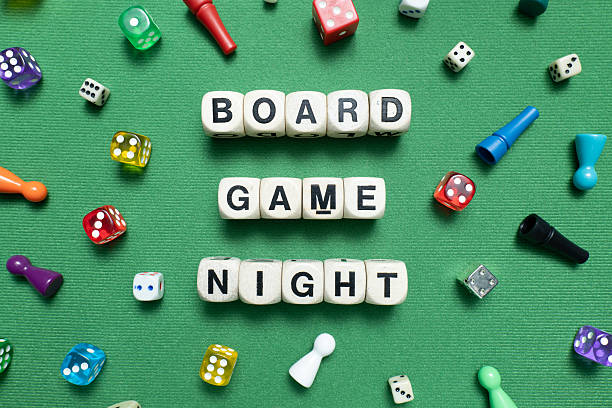 istock 'Board Game Night' spelt with wooden word dice. 2247279842