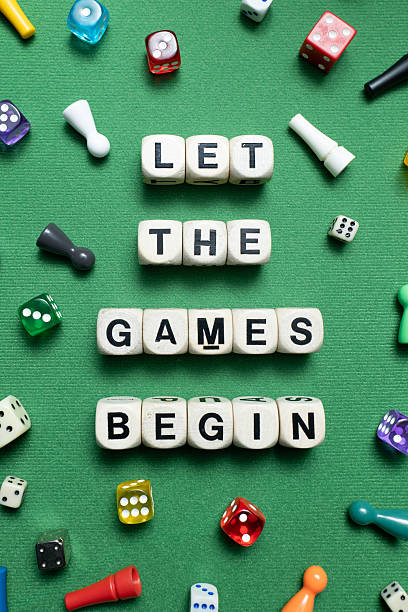 istock 'Let The Games Begin' spelt with wooden dice. 2247279889