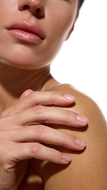 istock Woman touching bare shoulder showing soft hydrated skin and calm mood 2247283765