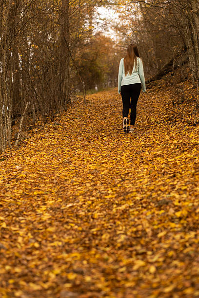 istock Woman hiking alone in the forest 2247284124