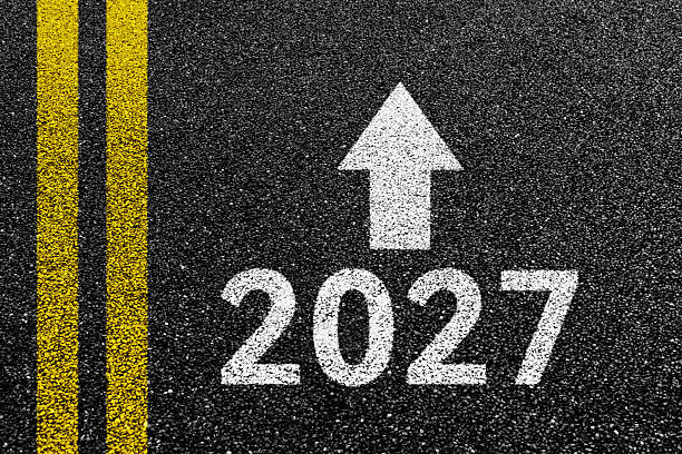 istock New year number 2027 with white arrow on asphalt road 2247284777