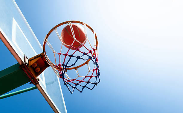 istock Basketball in a net against blue sky 2247284798